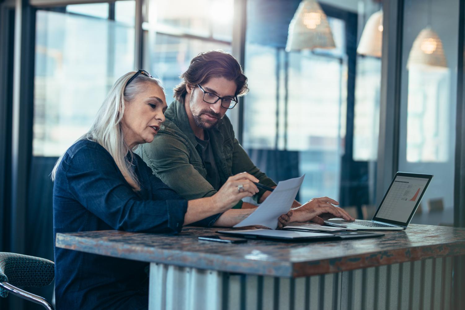 Woman and man assessing documents