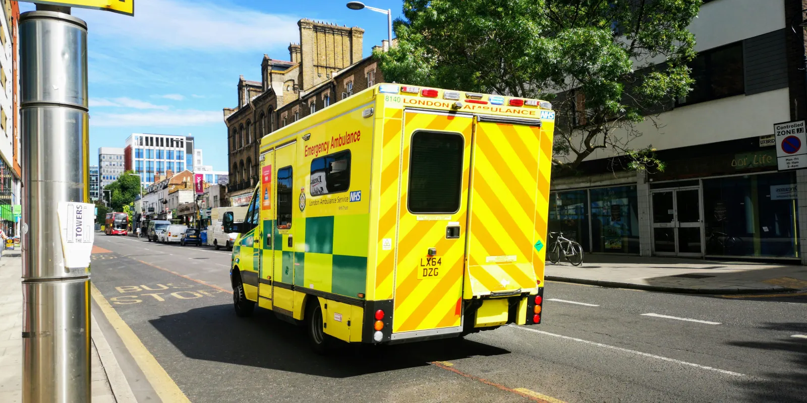 NHS Ambulance Driving Along a Road