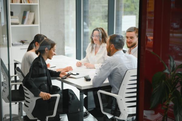 group of adults working around board room table