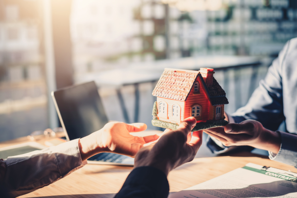 man handing over a house