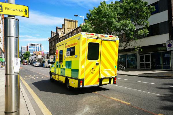 NHS Ambulance Driving Along a Road