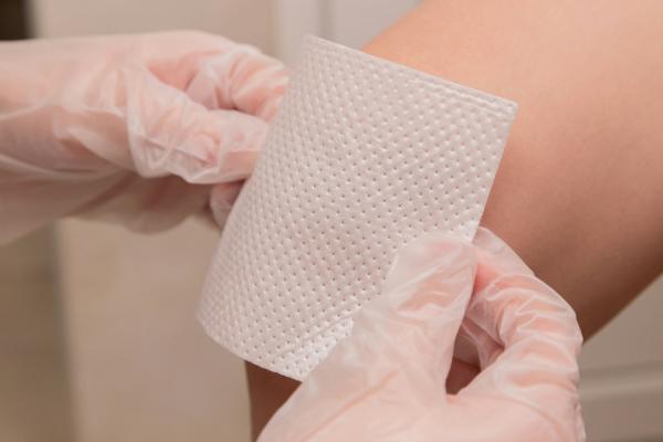 Medical dressing being applied to a patient